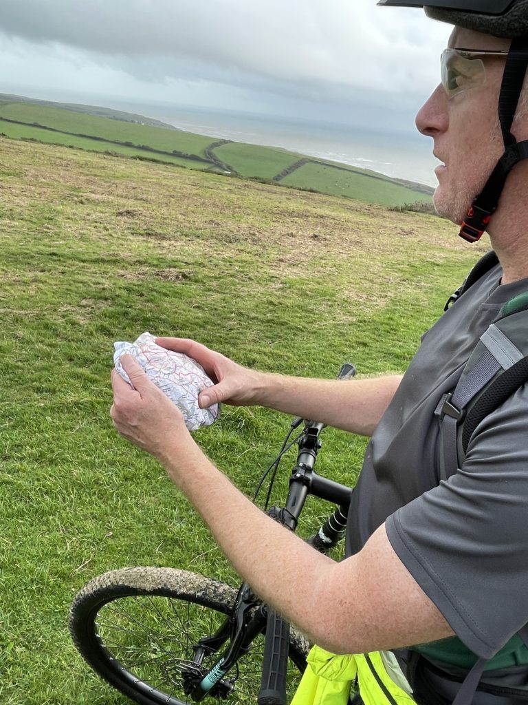 Checking the trail with a rainproof fabric map from SplashMaps